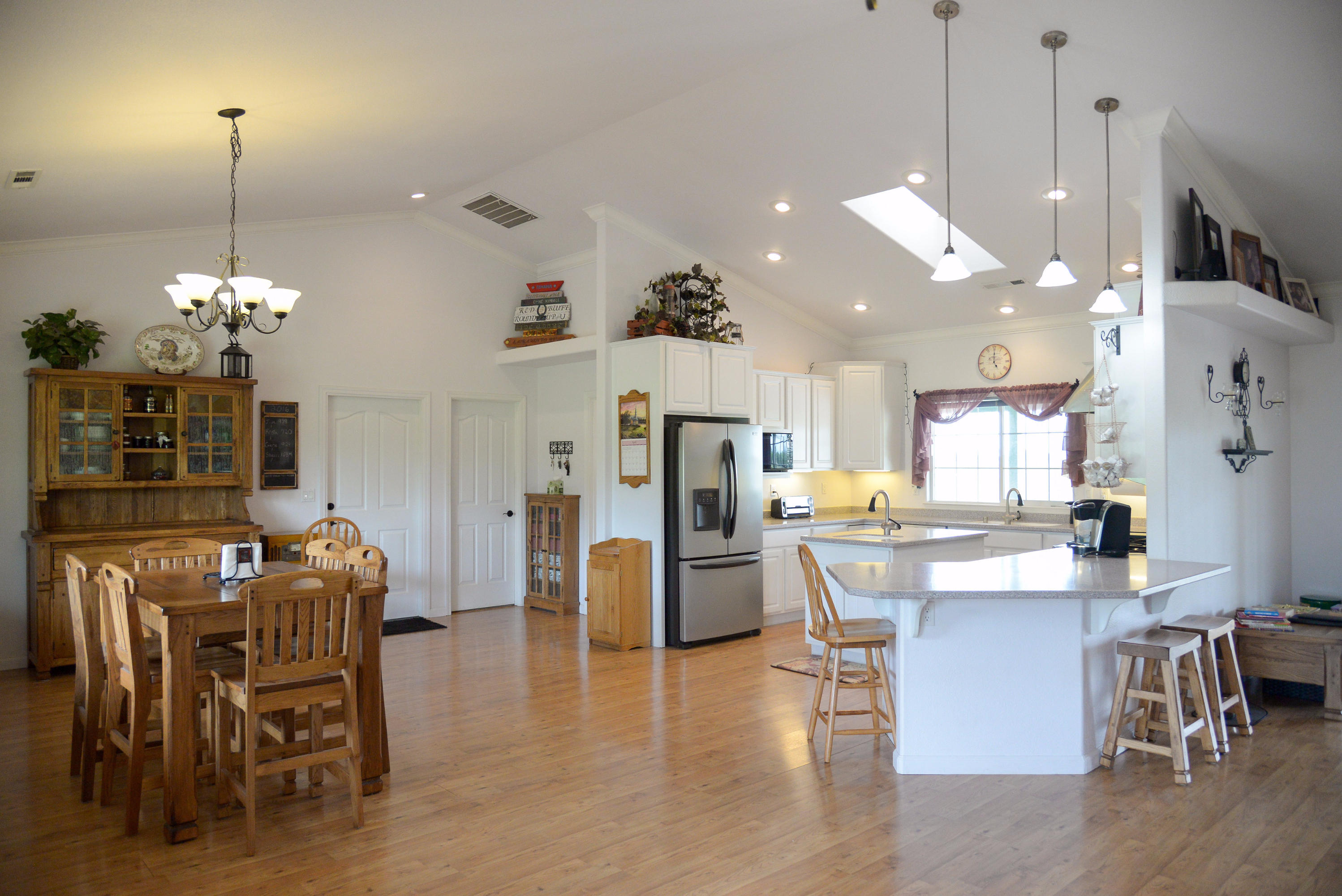 20765 Live Oak Road Red Bluff, CA 96080 - Photo 30 of 30 a view of a dining room and livingroom with furniture wooden floor a chandelier