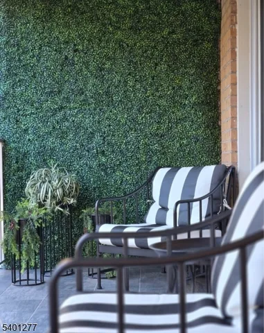 a view of a chairs and table in the balcony