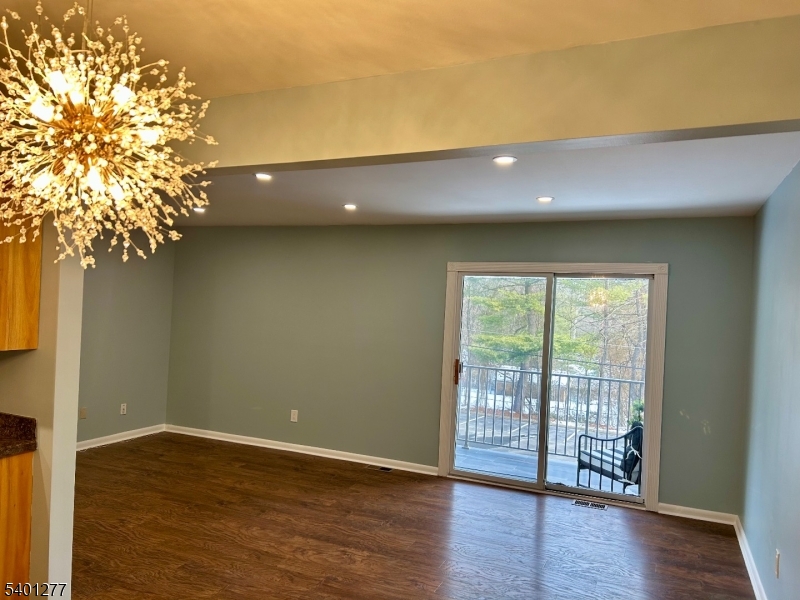 2350 State Route 10, Unit 20 Morris Plains, NJ 07950 - Photo 6 of 13 a view of an empty room with wooden floor and a window