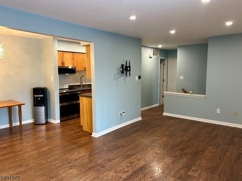 2350 State Route 10, Unit 20 Morris Plains, NJ 07950 - Photo 7 of 13 a view of a kitchen with wooden floor and a ceiling fan