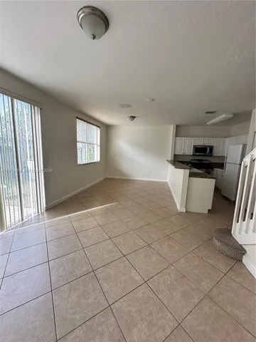 a view of an empty room with stairs