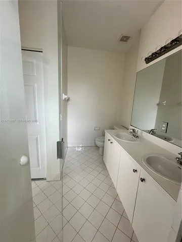 a bathroom with a glass shower door