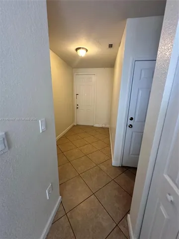 a spacious bathroom with a toilet a sink and mirror