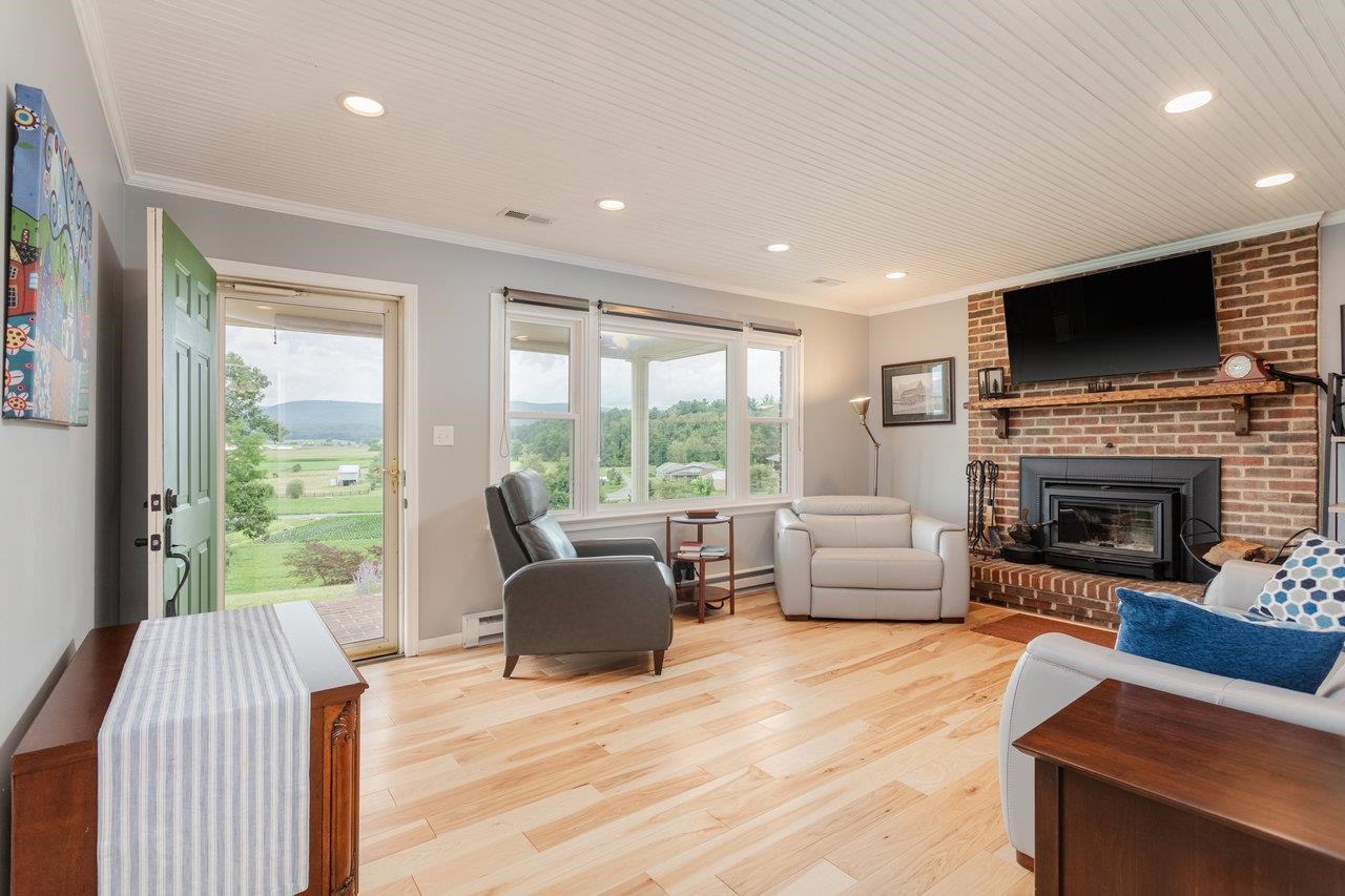 5566 Briery Branch Road Dayton, VA 22821 - Photo 3 of 75 a living room with furniture a flat screen tv and a fireplace