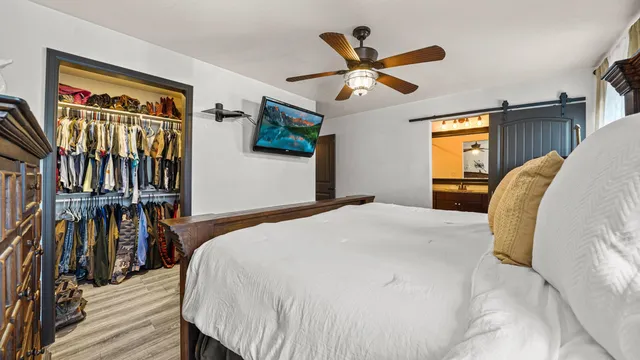 a bedroom with a bed and a chandelier