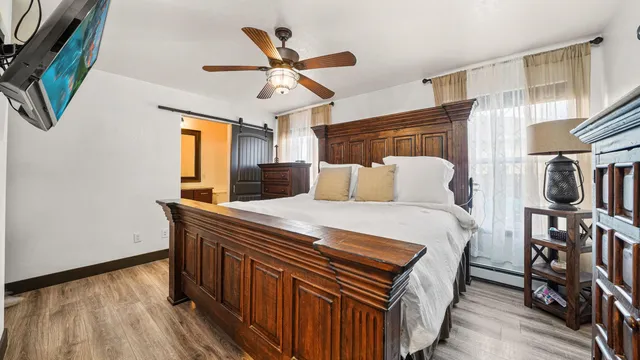 a bedroom with a bed and wooden floor