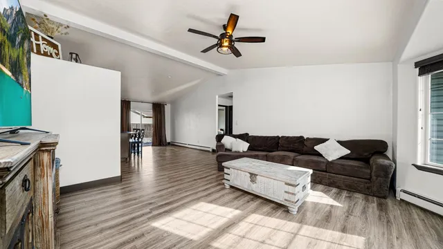 a living room with furniture and a wooden floor