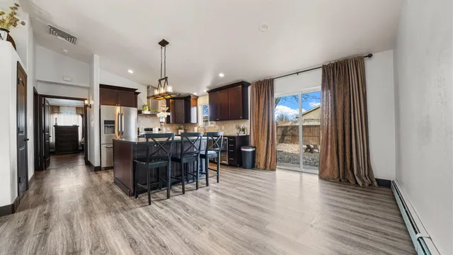 a view of a dining room with furniture window and wooden floor