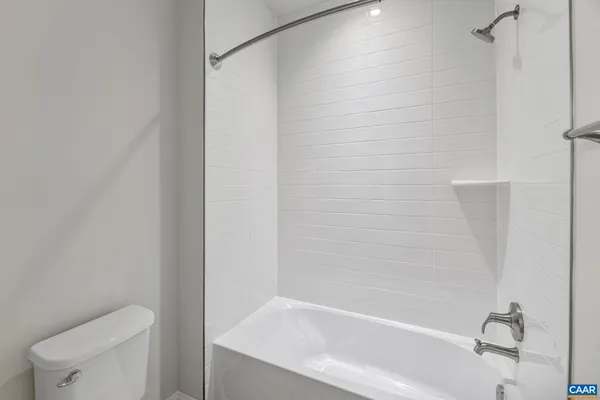 a bathroom with a bathtub and a toilet