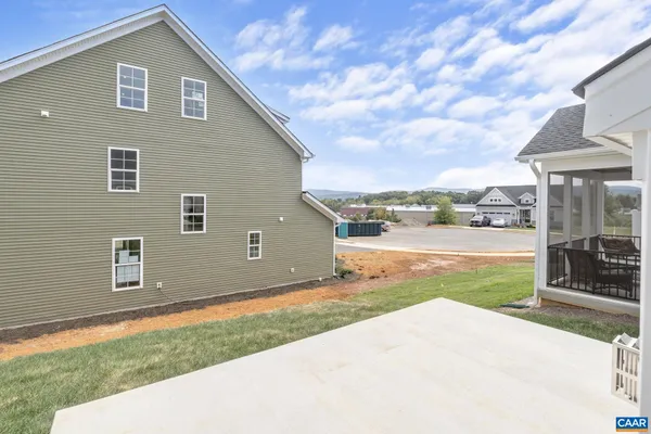 a view of a house with a yard and fence