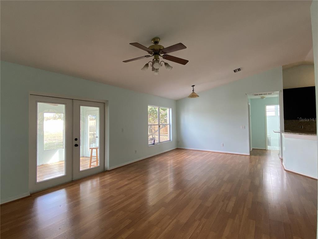 11328 Jim Court Riverview, FL 33569 - Photo 18 of 26 wooden floor in an empty room with a window