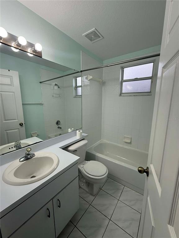 11328 Jim Court Riverview, FL 33569 - Photo 6 of 26 a bathroom with a sink a toilet a mirror a vanity and shower