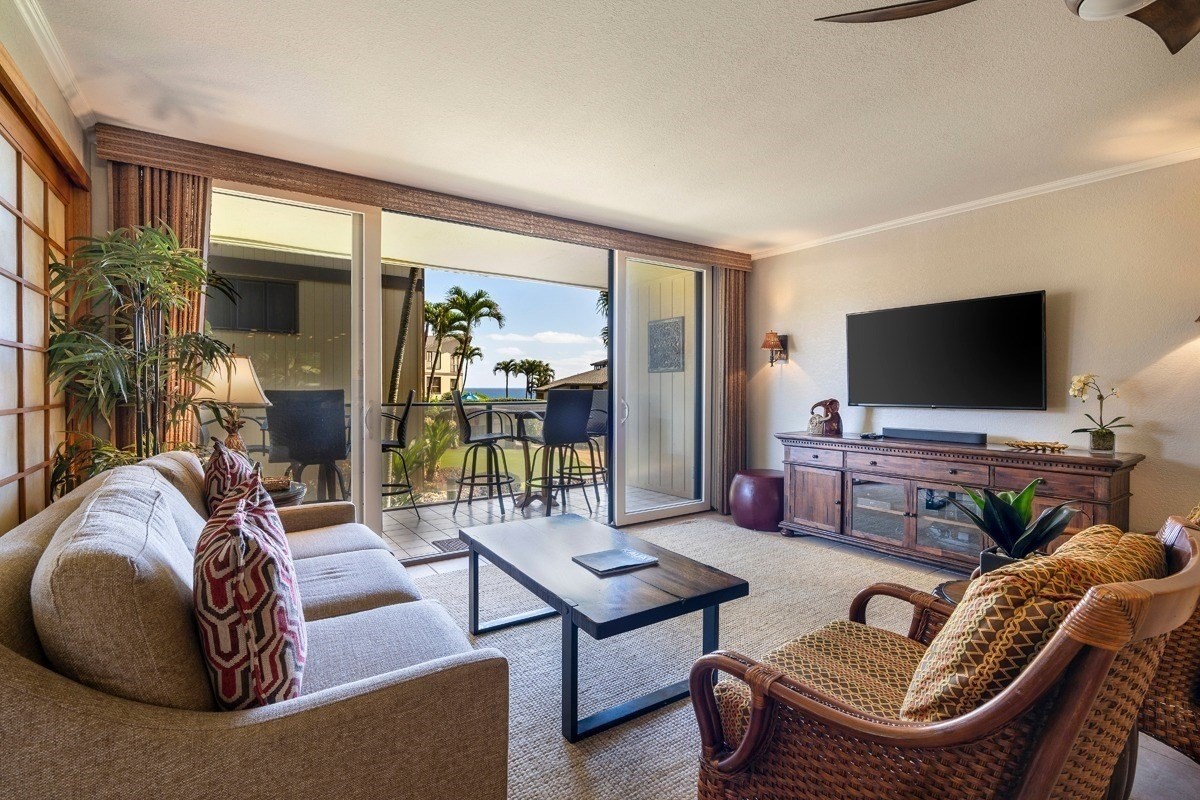 1661 Pee Road, Unit I202 Koloa, HI 96756 - Photo 2 of 11 a living room with furniture and a flat screen tv