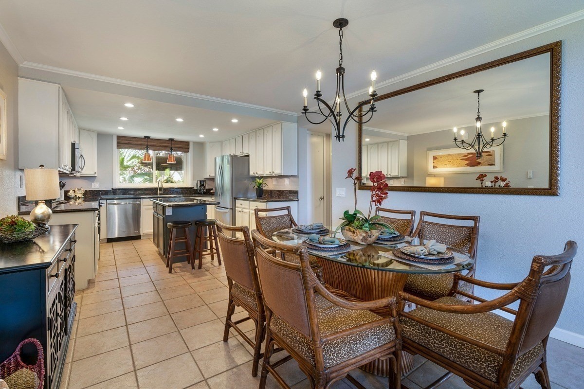 1661 Pee Road, Unit I202 Koloa, HI 96756 - Photo 3 of 11 a dining room filled chandelier and kitchen view
