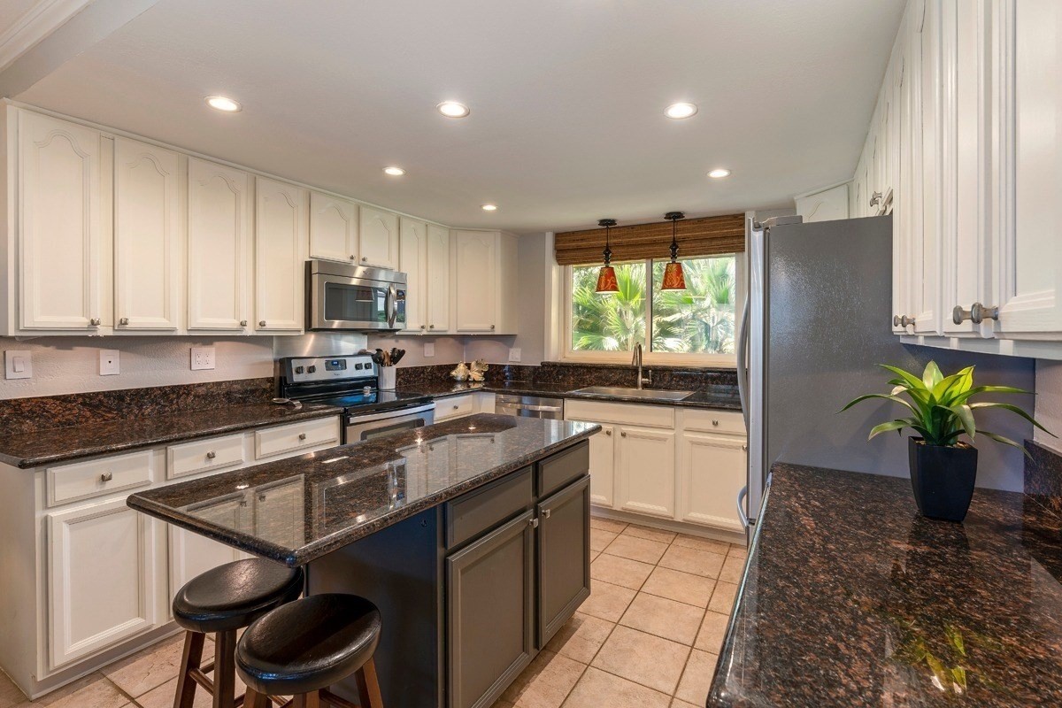 1661 Pee Road, Unit I202 Koloa, HI 96756 - Photo 4 of 11 a kitchen with a sink a window and appliances