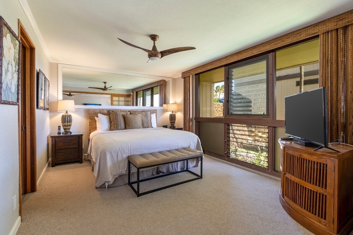 1661 Pee Road, Unit I202 Koloa, HI 96756 - Photo 5 of 11 a bedroom with a large bed and a flat tv screen on dresser