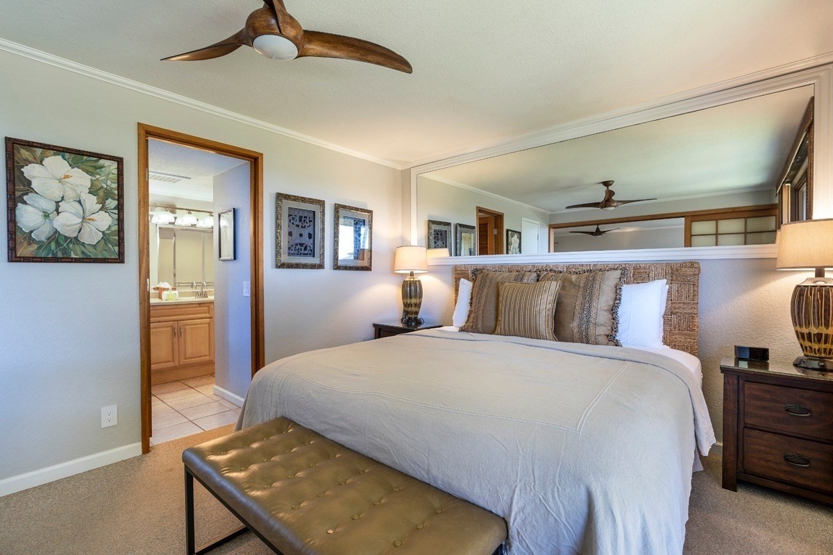 1661 Pee Road, Unit I202 Koloa, HI 96756 - Photo 6 of 11 a bedroom with a large bed and a chandelier