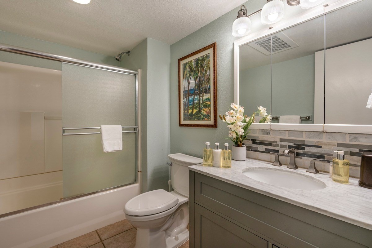 1661 Pee Road, Unit I202 Koloa, HI 96756 - Photo 8 of 11 a bathroom with a granite countertop sink toilet and shower