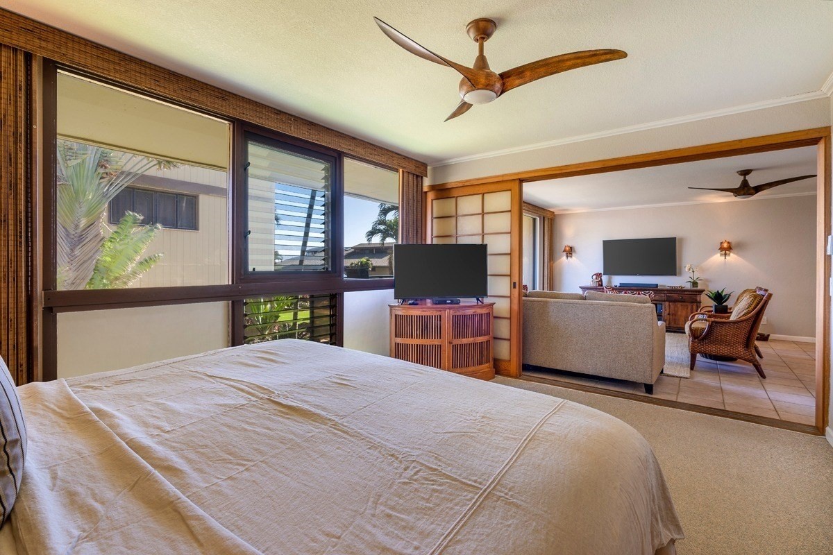 1661 Pee Road, Unit I202 Koloa, HI 96756 - Photo 9 of 11 a bedroom with a bed and a large window with the outer view