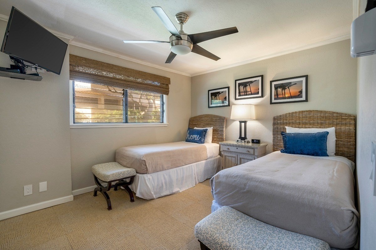 1661 Pee Road, Unit I202 Koloa, HI 96756 - Photo 10 of 11 a bedroom with two beds and a ceiling fan