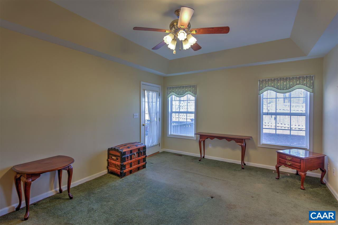 32 Zephyr Road Palmyra, VA 22963 - Photo 22 of 31 a living room with furniture a chandelier and a window
