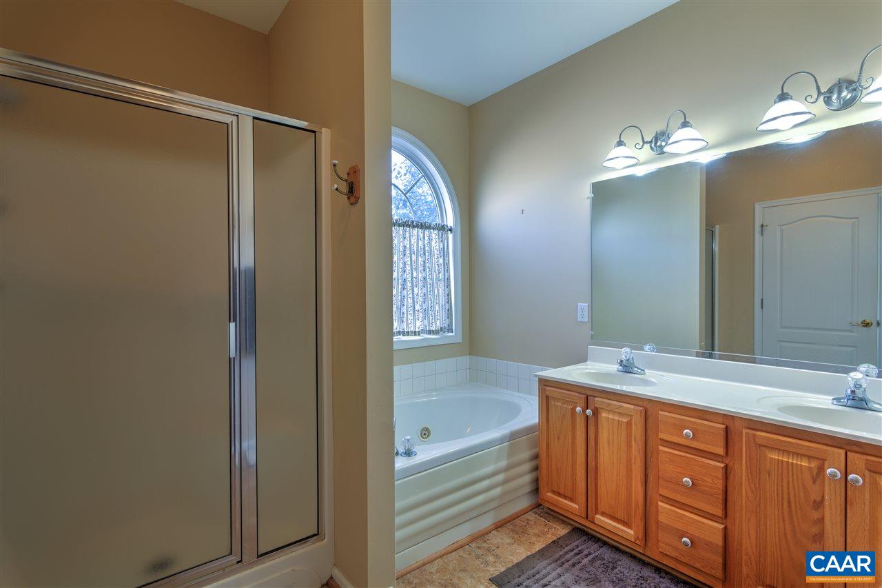 32 Zephyr Road Palmyra, VA 22963 - Photo 24 of 31 a bathroom with a double vanity sink and a mirror
