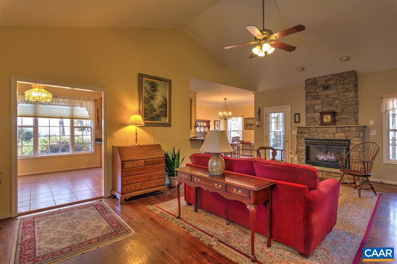 32 Zephyr Road Palmyra, VA 22963 - Photo 5 of 31 a living room with furniture a fireplace and a chandelier