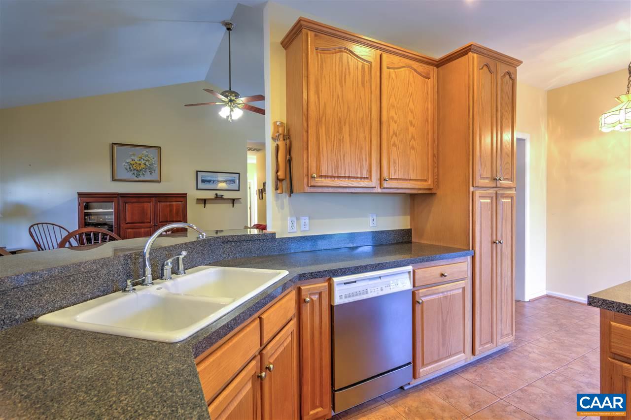 32 Zephyr Road Palmyra, VA 22963 - Photo 9 of 31 a kitchen with stainless steel appliances granite countertop a sink a microwave cabinets and a dining table