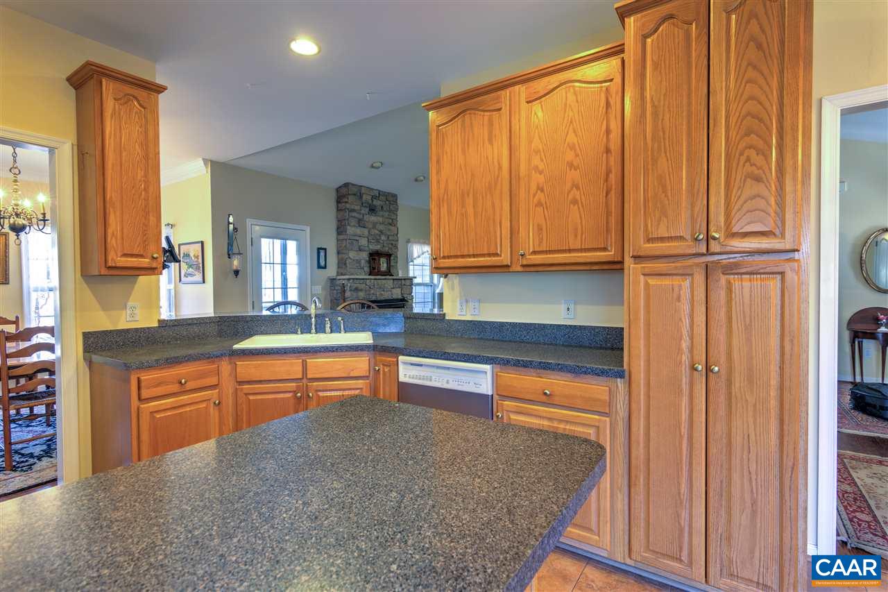 32 Zephyr Road Palmyra, VA 22963 - Photo 10 of 31 a kitchen with stainless steel appliances granite countertop wooden cabinets a sink and a large window