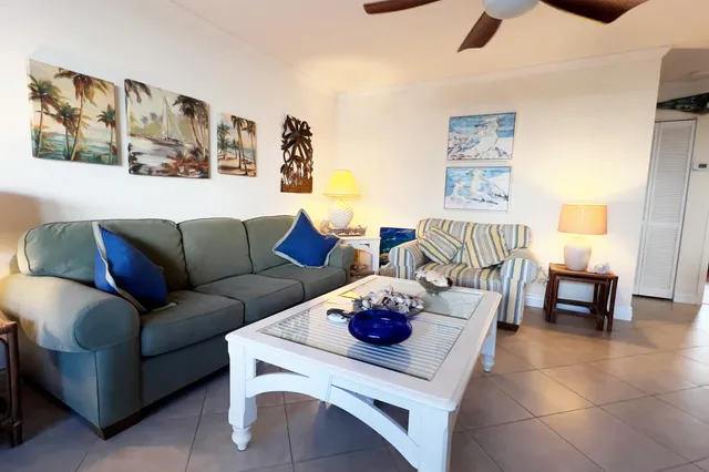 a living room with furniture and kitchen view
