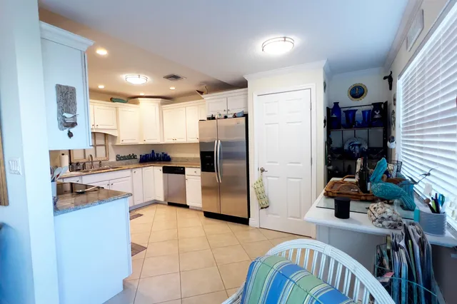a kitchen with stainless steel appliances kitchen island granite countertop a refrigerator and a stove