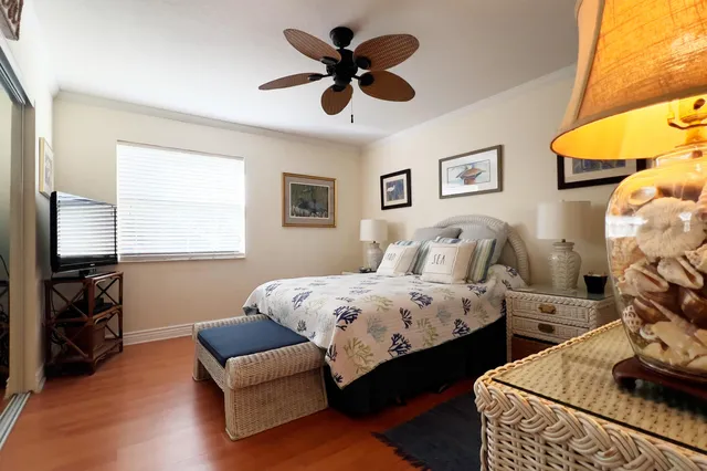 a spacious bedroom with two beds and a flat screen tv