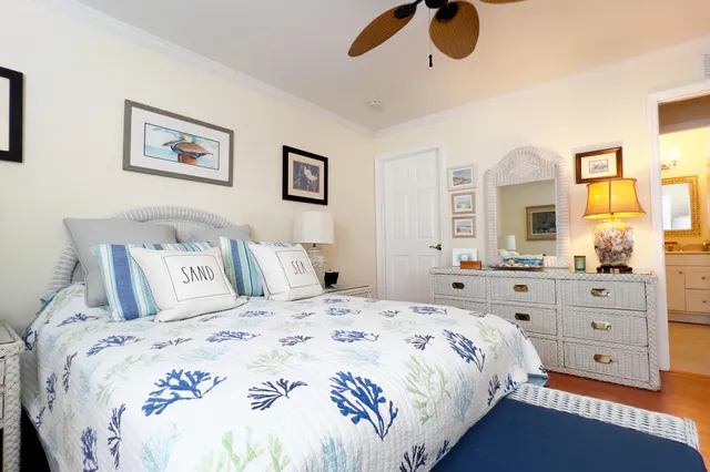 a bedroom with a bed and painting on the wall