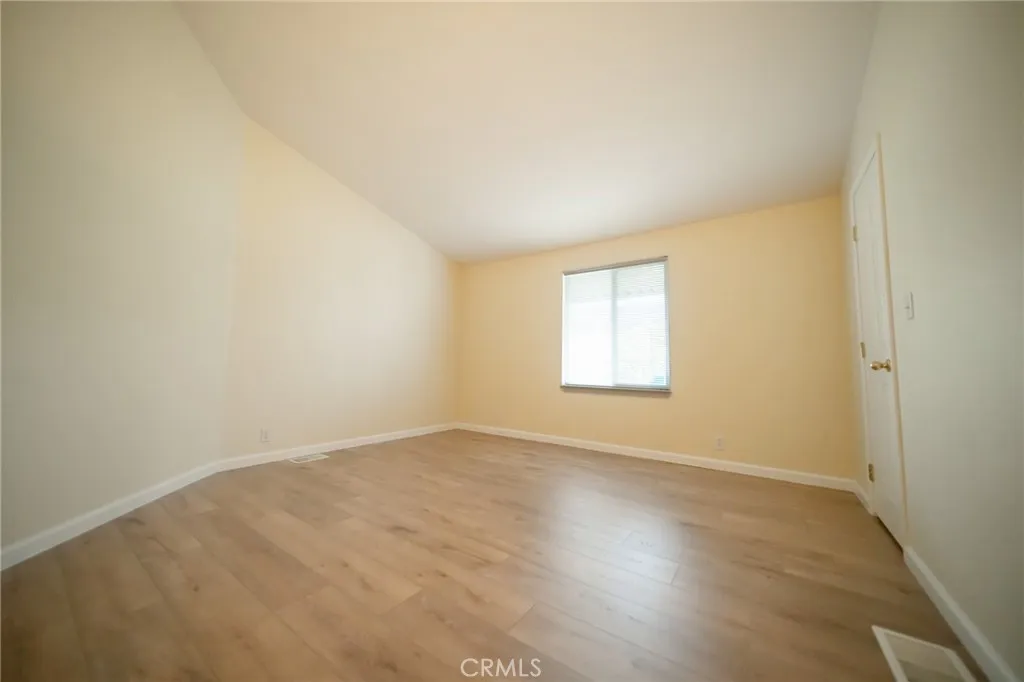 49 Pine Via Anaheim, CA 92802 - Photo 17 of 23 an empty room with wooden floor and windows