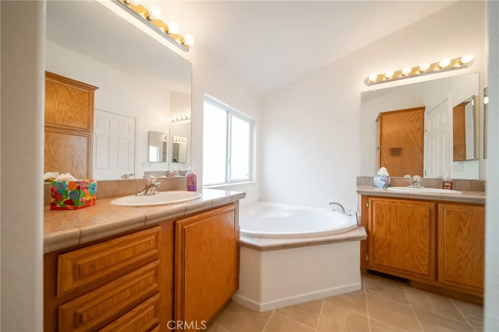 49 Pine Via Anaheim, CA 92802 - Photo 22 of 23 a bathroom with a sink double vanity granite tub and a mirror