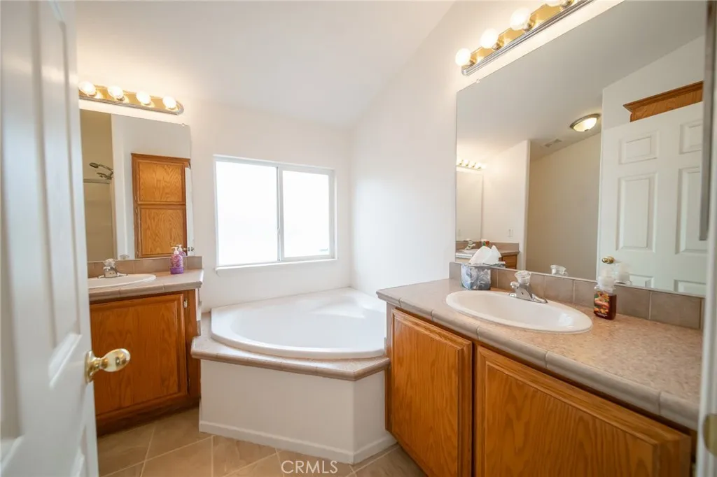 49 Pine Via Anaheim, CA 92802 - Photo 23 of 23 a bathroom with a tub sink and mirror