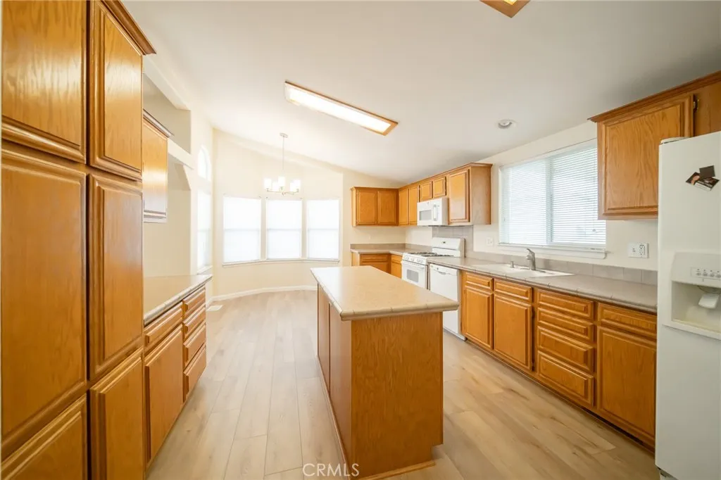 49 Pine Via Anaheim, CA 92802 - Photo 10 of 23 a large kitchen with stainless steel appliances granite countertop a large window a sink and cabinets