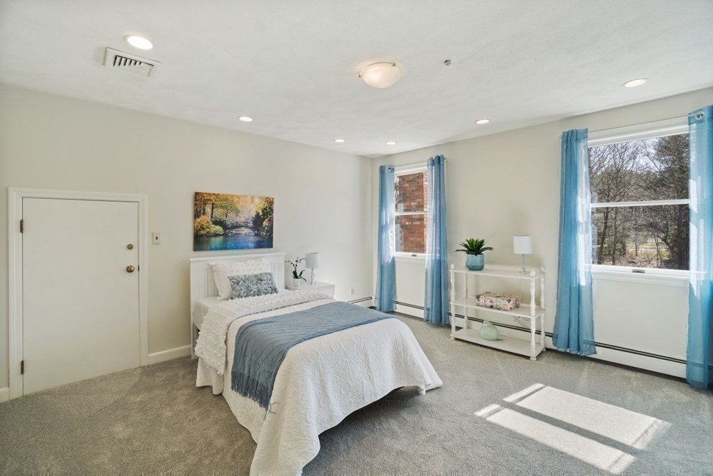 89 Plain Road Wayland, MA 01778 - Photo 24 of 30 a bedroom with a large bed and a window