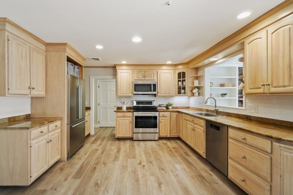 89 Plain Road Wayland, MA 01778 - Photo 4 of 30 a large kitchen with stainless steel appliances granite countertop a stove and a sink