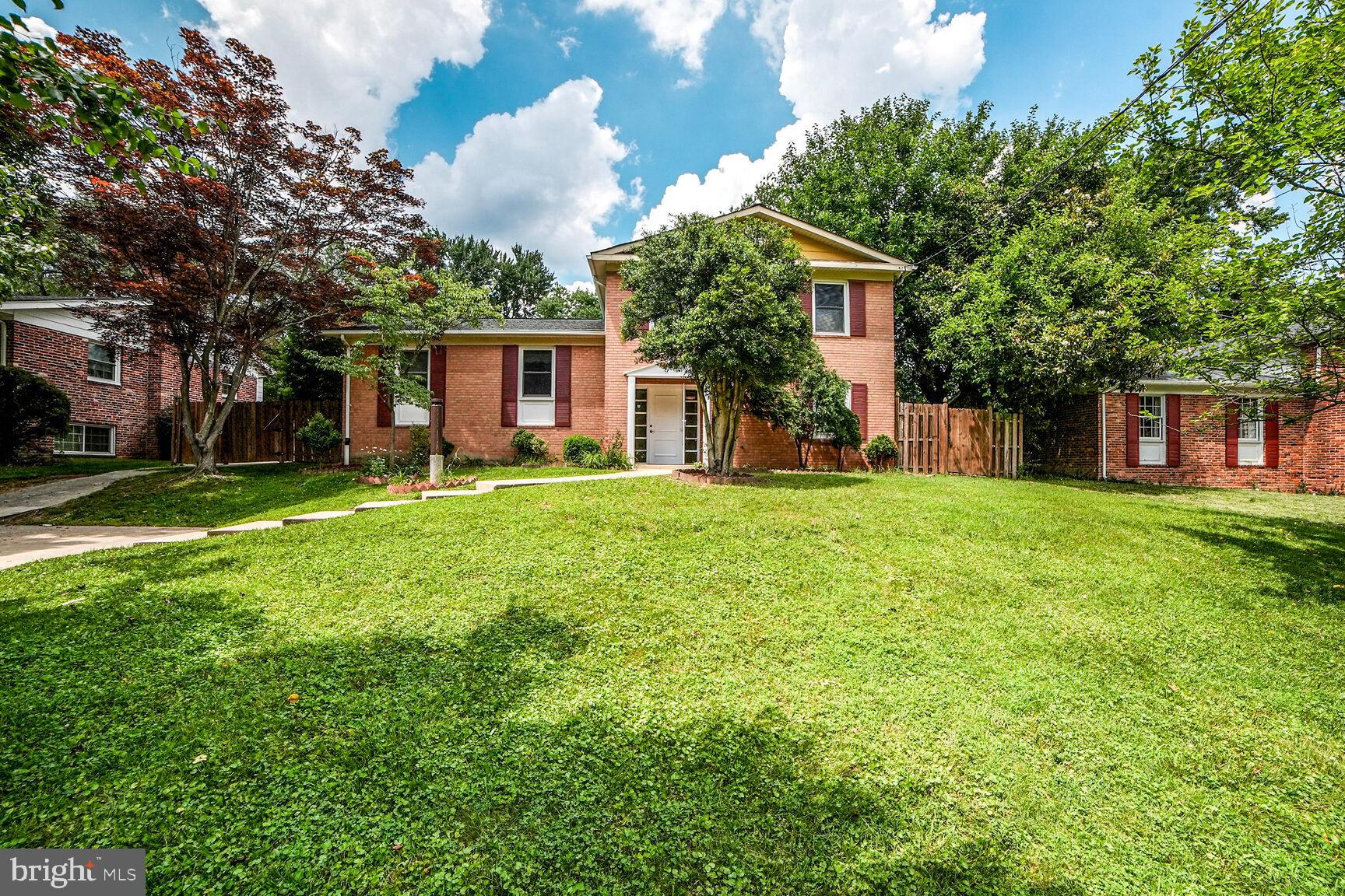 a house view with a sitting space and garden