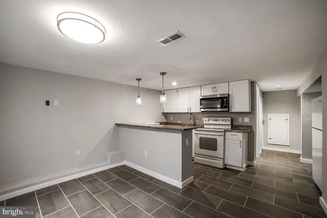 a kitchen with a stove cabinets and a sink
