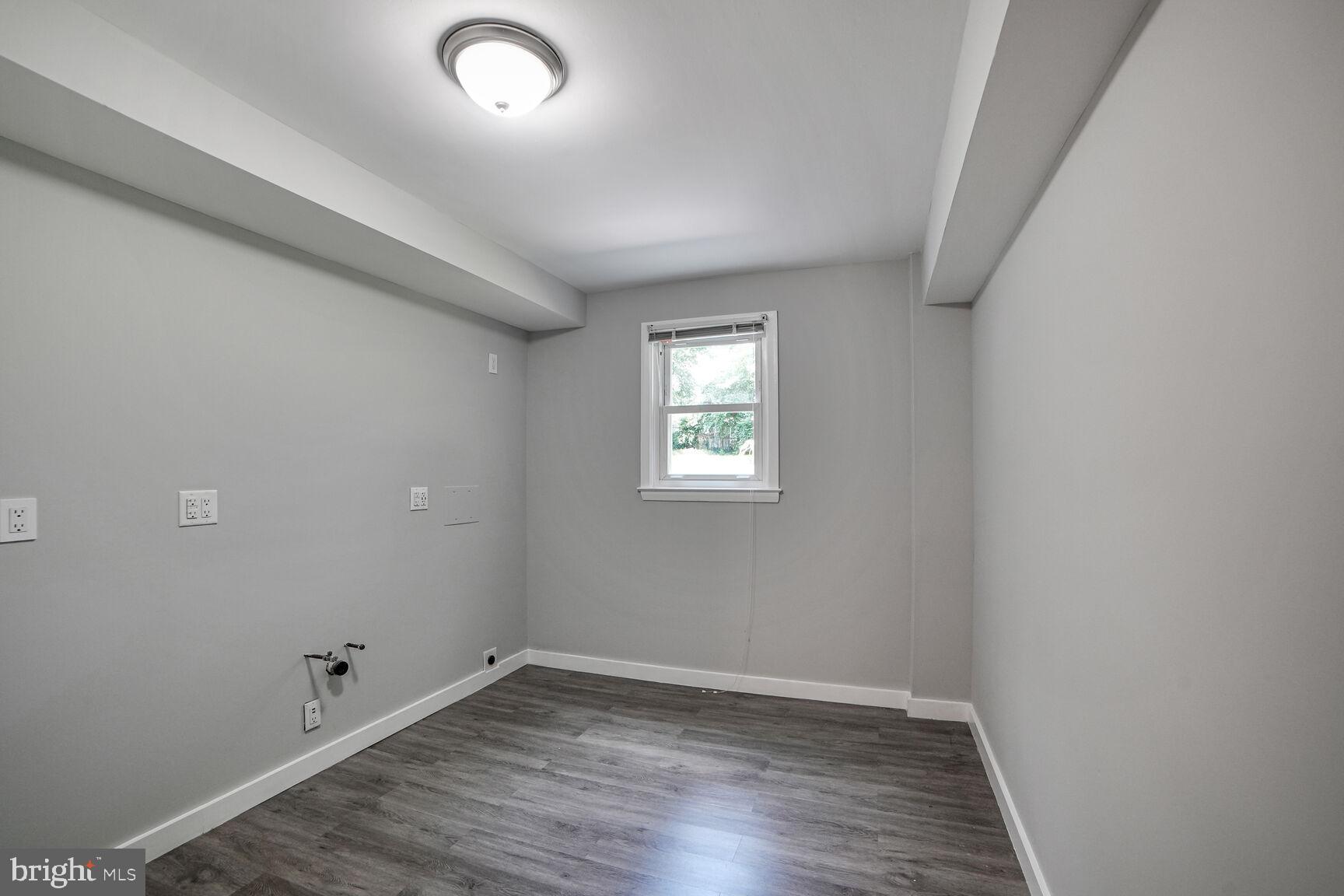 716 Downs Drive Silver Spring, MD 20904 - Photo 13 of 33 an empty room with wooden floor and windows