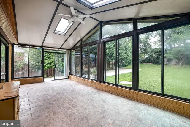 a view of an empty room with windows and a balcony