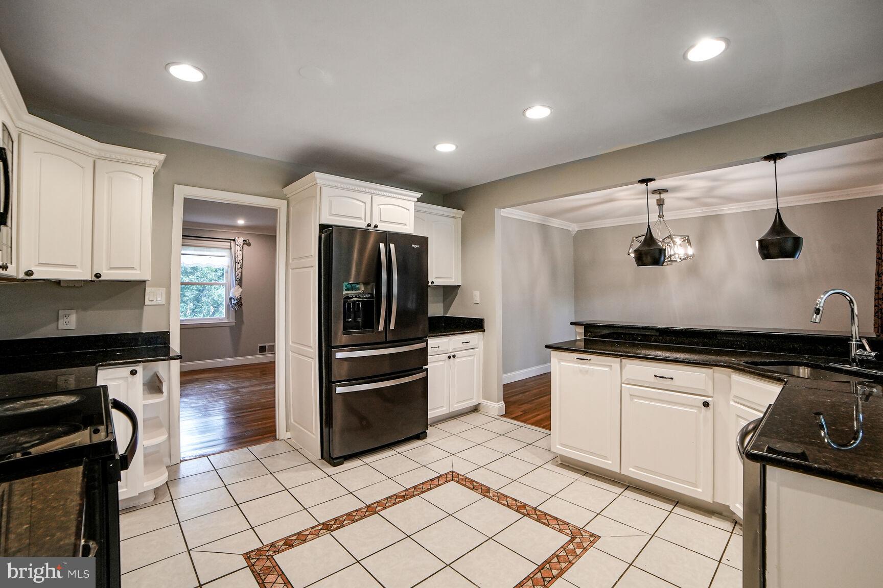 716 Downs Drive Silver Spring, MD 20904 - Photo 5 of 33 a kitchen with granite countertop a refrigerator and a stove top oven