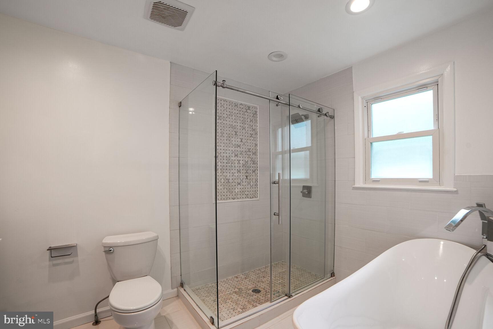 716 Downs Drive Silver Spring, MD 20904 - Photo 10 of 33 a bathroom with a shower a toilet and sink