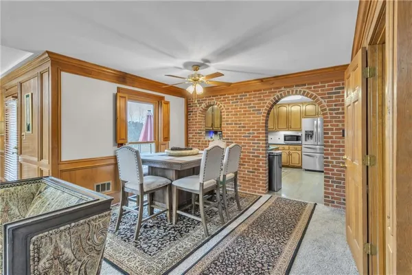 a dining room with furniture a rug and a chandelier