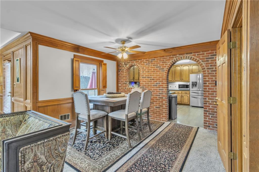 838 Conyers Road McDonough, GA 30252 - Photo 11 of 31 a dining room with furniture a rug and a chandelier