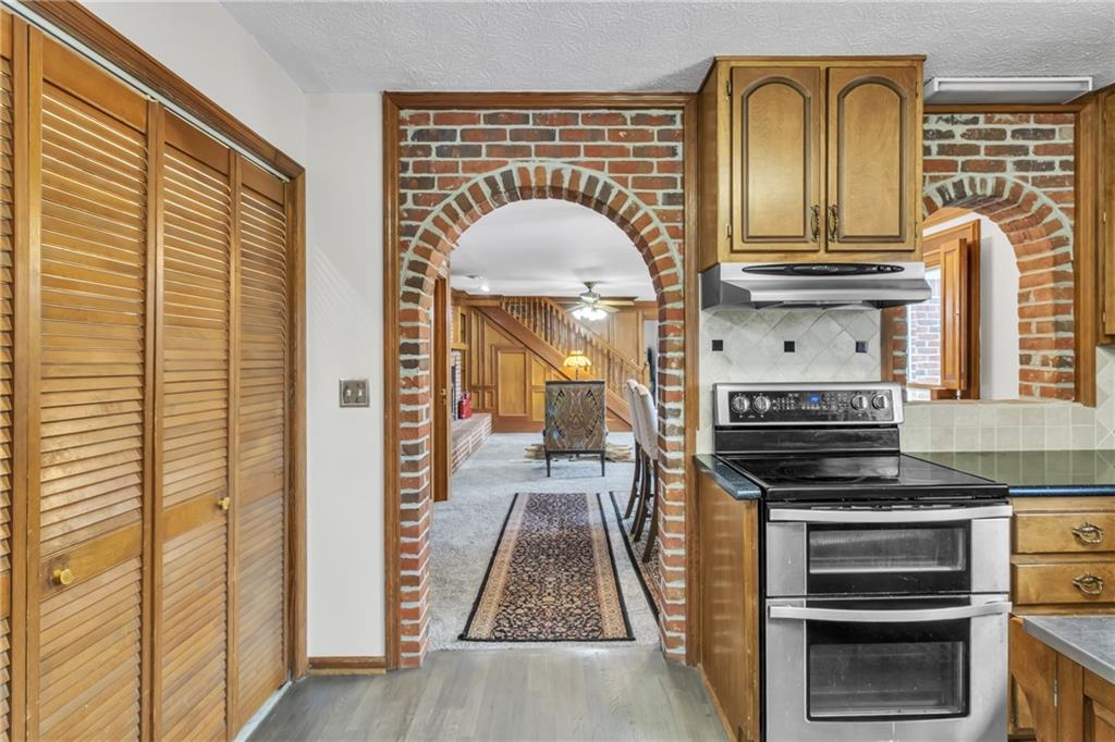 838 Conyers Road McDonough, GA 30252 - Photo 14 of 31 a kitchen with stainless steel appliances granite countertop a stove and a wooden cabinets