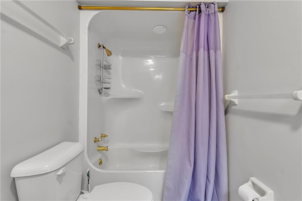 838 Conyers Road McDonough, GA 30252 - Photo 20 of 31 a bathroom with a toilet and a shower