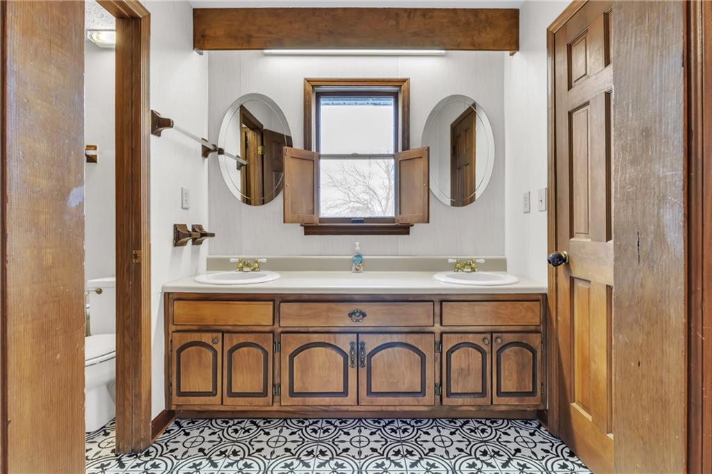 838 Conyers Road McDonough, GA 30252 - Photo 23 of 31 a bathroom with a sink and a mirror
